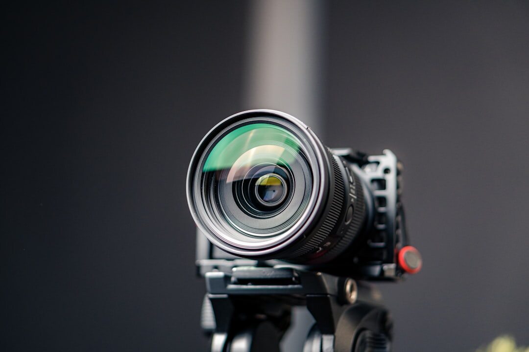 Close-up of professional broadcast camera positioned on tripod in studio