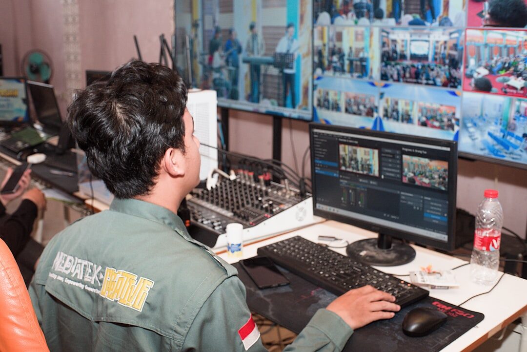 News director reviewing shot composition on professional monitors in control room