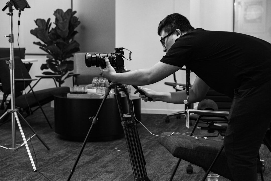 Camera operator adjusting framing angles and demonstrating shot techniques